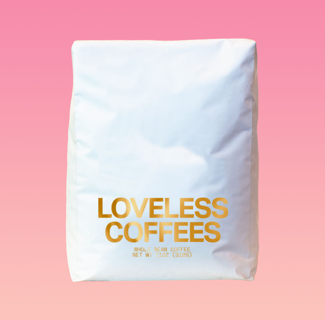 A white 5 pound bag of coffee roasted by Loveless Coffees on pink background