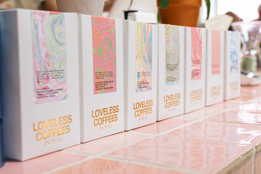 Loveless Coffees packaging displayed on pink tile counter