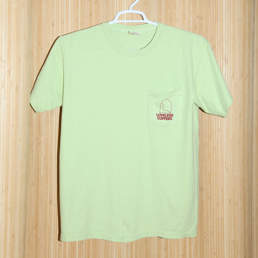 A light green pocket t-shirt with 'LOVELESS COFFEES' text in red on the pocket.