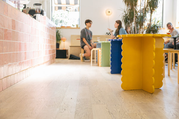 Colorful small tables inside Loveless Cafe with people enjoying coffee in the background