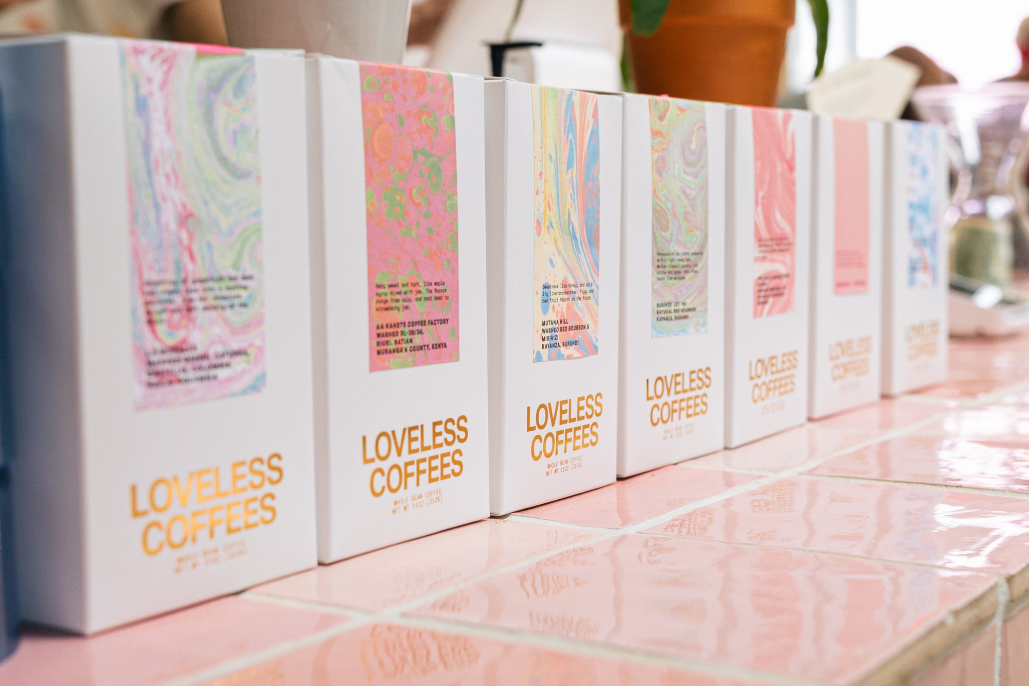 Loveless Coffees packaging displayed on pink tile counter 