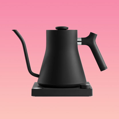 A black & stainless steel pour-over kettle with a gooseneck spout and a black handle, sitting on a black base.
