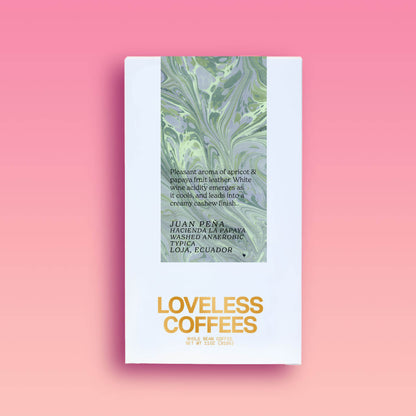 A package of coffee beans with a green and white design, labeled 'Loveless Coffees,' produced by Juan Pena in Ecuador